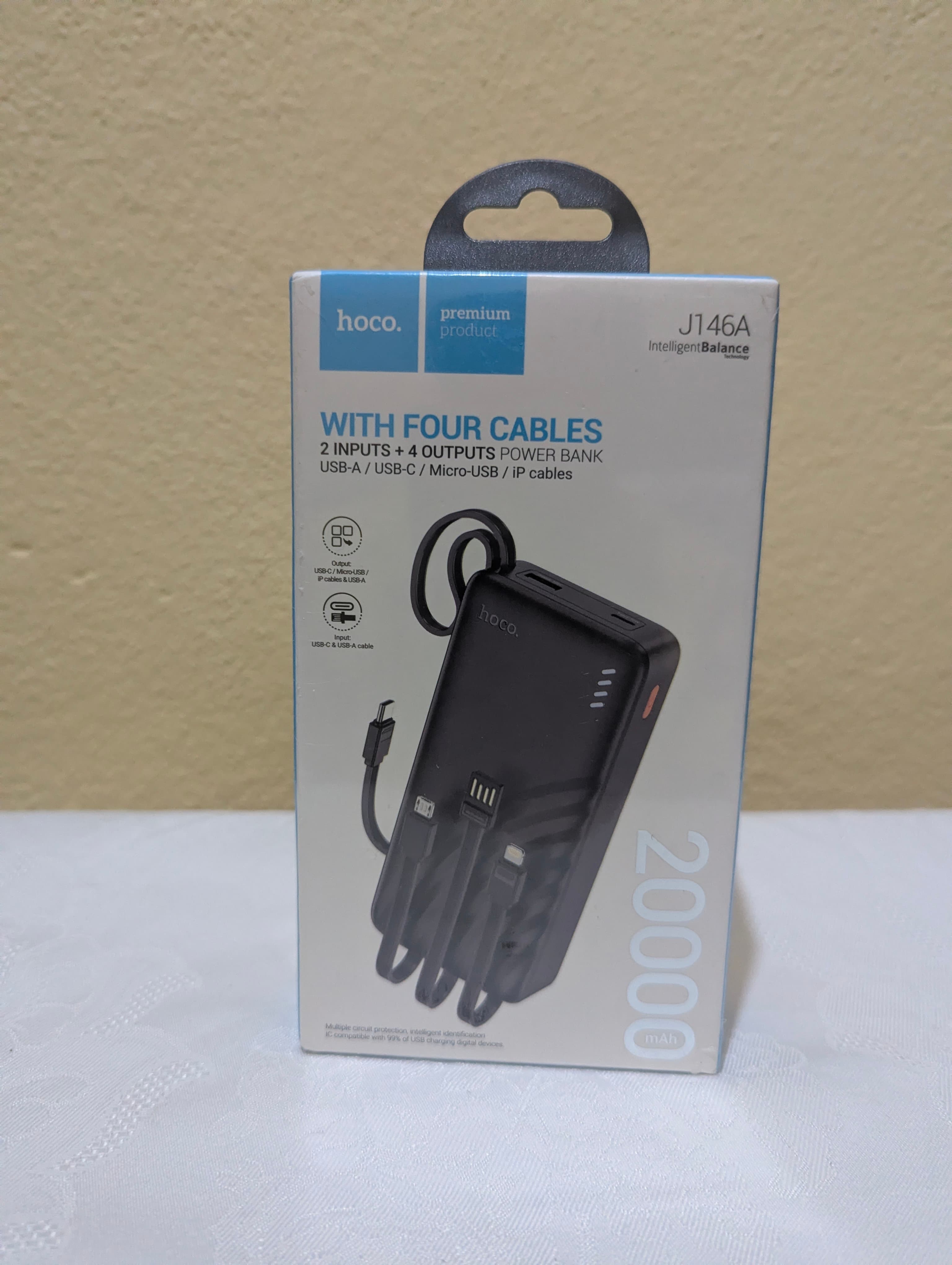 Batterie Externe Hoco J146A 20000mAh avec 4 Câbles Intégrés (Type-C, Lightning, Micro-USB, USB-A)